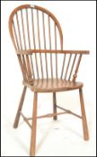 A Victorian beech and elm wood Windsor armchair. Raised on turned legs with stretchers having a