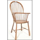 A Victorian beech and elm wood Windsor armchair. Raised on turned legs with stretchers having a