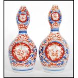 A pair of 19th century Chinese Imari pattern gourd vases, each with polychrome decoration with