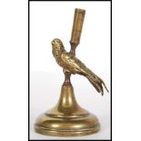 A late 19th / early 20th Century brass incense burner molded as a bird perching on a stand, having