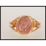 A hallmarked 9ct gold signet ring having a central round panel engraved ' Cissie '. Hallmarked