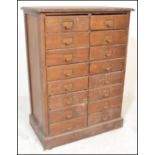 A 20th Century Industrial pine multi drawer tool chest / filing cabinet consisting of sixteen