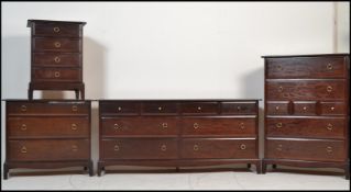 A Stag mahogany ' minstrel ' pattern bedroom suite comprising a large double chest of drawers, a