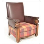 A 1930's Art Deco oak club type armchair raised on square carved supports with bulbous ball arm