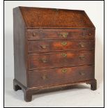 An 18th century country oak bureau. Raised on bracket feet having a chest of drawers beneath fall