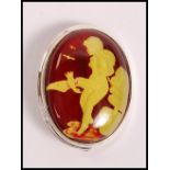 A stamped 925 silver cameo brooch having a glass panel carved with a nude female. Weight 13.4g.