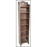 A tall early 20th century, circa 1920's Arts & Crafts oak library bookcase cabinet raised on bracket