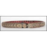 An unusual silver plated on bronze articulated belt applied to leather, believed late 19th early