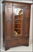 A 1920's oak single wardrobe in the Arts & Crafts style. Raised on bracket feet with single drawer