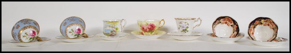 A group of 20th Century cabinet tea cups and saucers, having floral decoration with gilt detailing