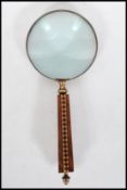 A 20th Century large desktop magnifying glass having a tunbridge style wooden square tapering handle