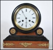 A 20th Century French style mantel clock on a plinth base with gilt scrolled detailing having a