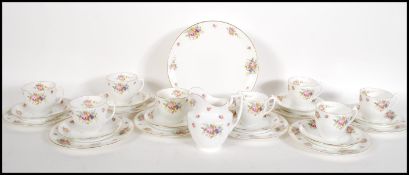 A early 20th Century Edwardian Royal Doulton tea service having floral sprays on white ground with