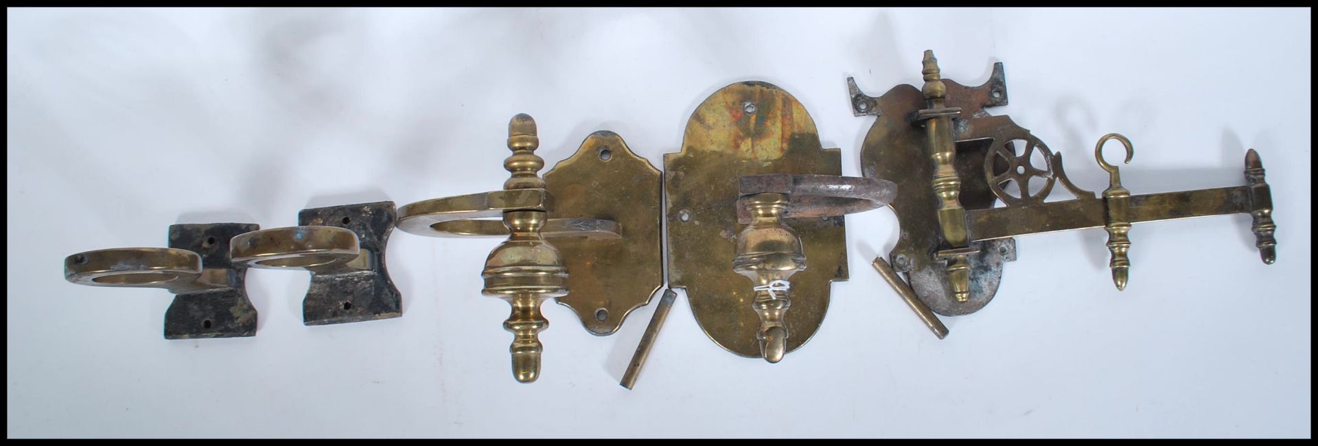 A small group of vintage brass brackets to include two carriage lantern holders, adjustable wall