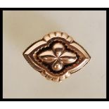 A 19th Century Victorian 9ct gold mourning brooch of quatrefoil form having a glazed panel to the