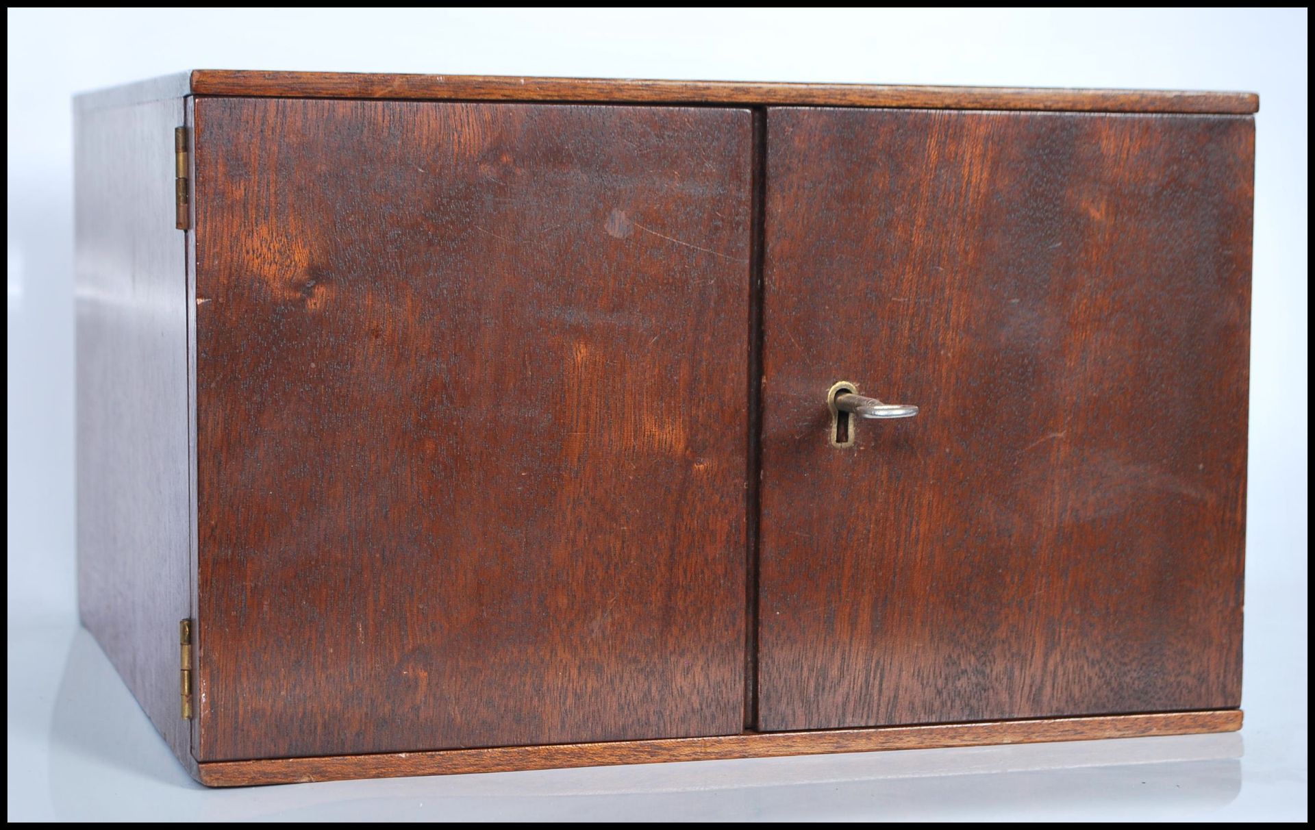 A mahogany coin collectors cabinet, fitted with 14 slide out drawers containing coins dating from