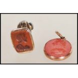 An early / mid 19th Century seal pendant having a red stone oval seal carved with a seated maiden