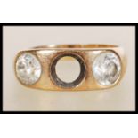 A stamped 18ct gold ring set with two round cut white stones (one missing). Weight 7.1g. Size T.