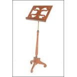 A late 19th Victorian / early 20th Century mahogany music / lectern stand, the adjustable central