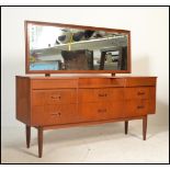 A vintage mid 20th Century teak wood Danish influenced dressing table, having a configuration of six