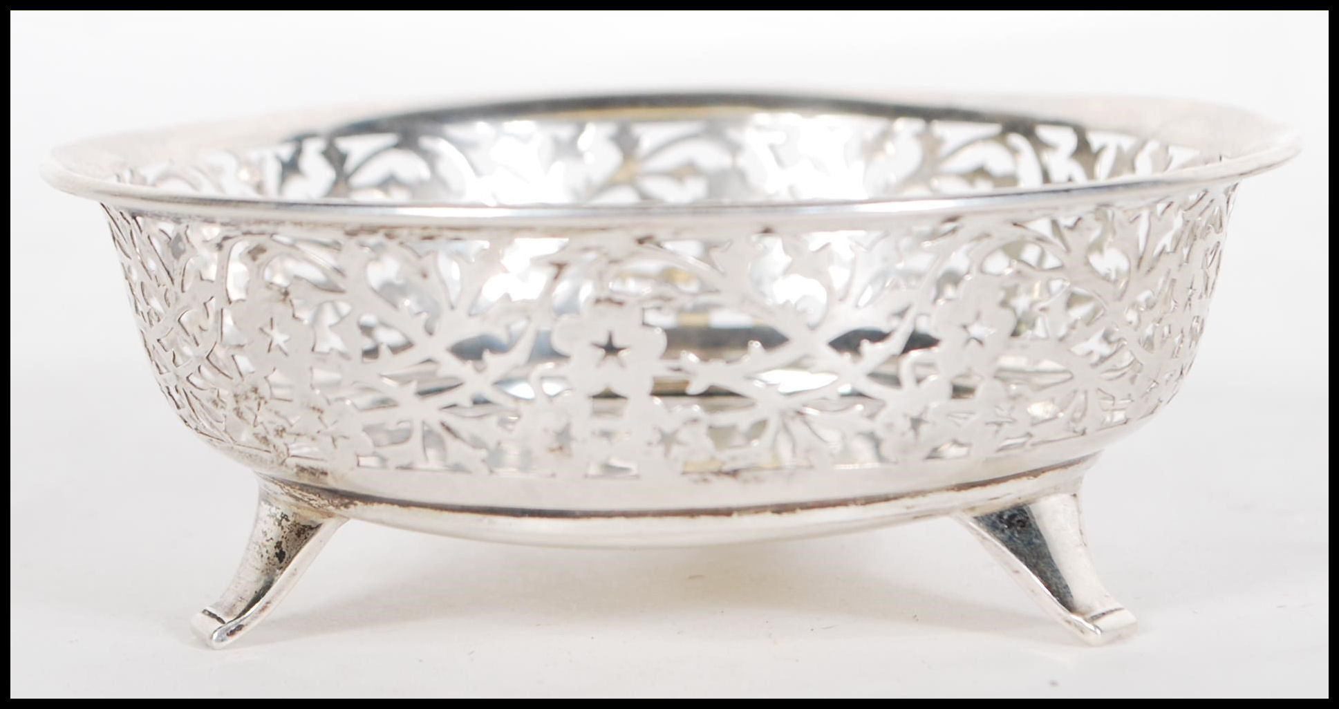 A early 20th Century silver hallmarked dish having pierced foliate decoration raised on three - Image 3 of 6