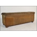 A large 19th century Victorian velour upholstered ottoman. Raised on bun feet, the wide body being