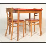 A retro mid century 1950's red formica and beech wood draw leaf dining table. The red formica top