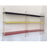 A retro 20th Century wall hanging metamorphic whatnot shelving system, constructed from metal