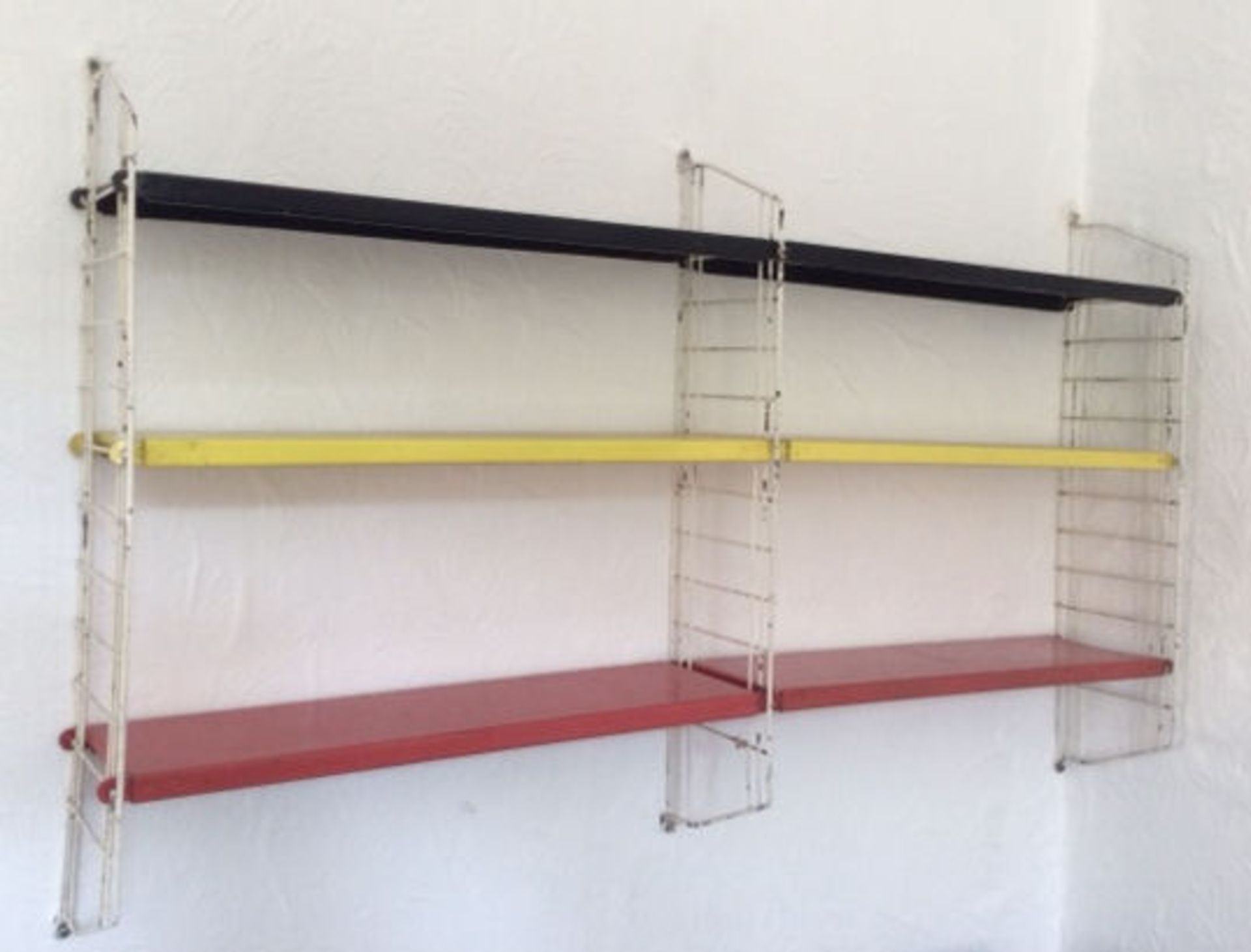 A retro 20th Century wall hanging metamorphic whatnot shelving system, constructed from metal