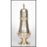 A 20th Century silver hallmarked sugar shaker sifter, with pierced domed top, baluster shaped body