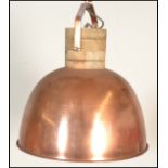 A vintage 20th Century industrial copper pendant ceiling light of domed form, having a black and