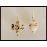 Two Georgian carved bone gaming dice / die spinning tops to include an octagonal spinner with