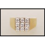 A hallmarked 375 9ct gold ring, prong set with nine white stones in square formation on a tapering