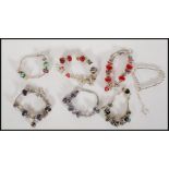 A group of six silver white metal Pandora style snake chain charm bracelets, each adorned with a