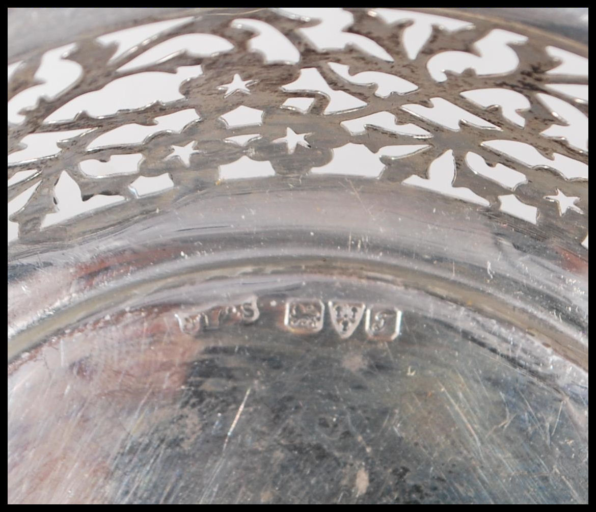 A early 20th Century silver hallmarked dish having pierced foliate decoration raised on three - Image 6 of 6