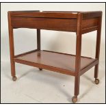 A retro 20th Century Danish teak wood two tiered buffet / drinks trolley, raised on shaped