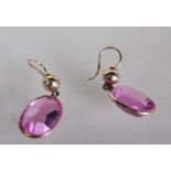A pair of stamped 375 9ct gold ladies drop earrings set with large oval cut pink synthetic