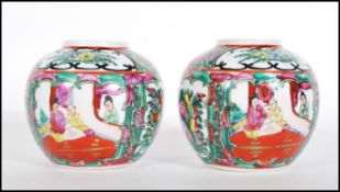 A matching pair of 20th Century Chinese ginger jars being of ovoid form hand decorated with floral