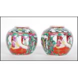 A matching pair of 20th Century Chinese ginger jars being of ovoid form hand decorated with floral