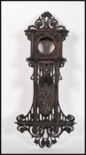 A early 20th Century Edwardian Black Forest style mahogany wall hanging clock case, having fret