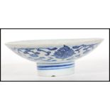 An 18th Century Chinese blue and white hand painted bowl of conical form raised on circular foot.