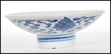 An 18th Century Chinese blue and white hand painted bowl of conical form raised on circular foot.