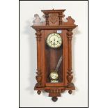 A 20th Century Vienna walnut cased regulator wall clock having a carved scallop shell pediment to