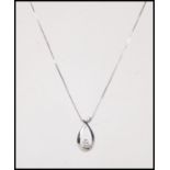 A 10ct white gold and diamond necklace and pendant
