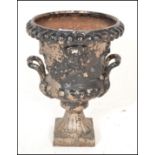 A 19th Century Victorian cast metal Campana urn planter having twin handles with raised lions mask