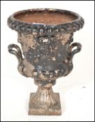 A 19th Century Victorian cast metal Campana urn planter having twin handles with raised lions mask