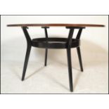 A 20th Century vintage teak wood and ebonised circular dining table  of sputnik / atomic form having