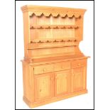 An antique style large country pine welsh dresser. The base with a series of drawers and cupboards