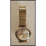 A vintage mid 20th Century Cyma 9ct gold case wrist watch having a round face with a silvered