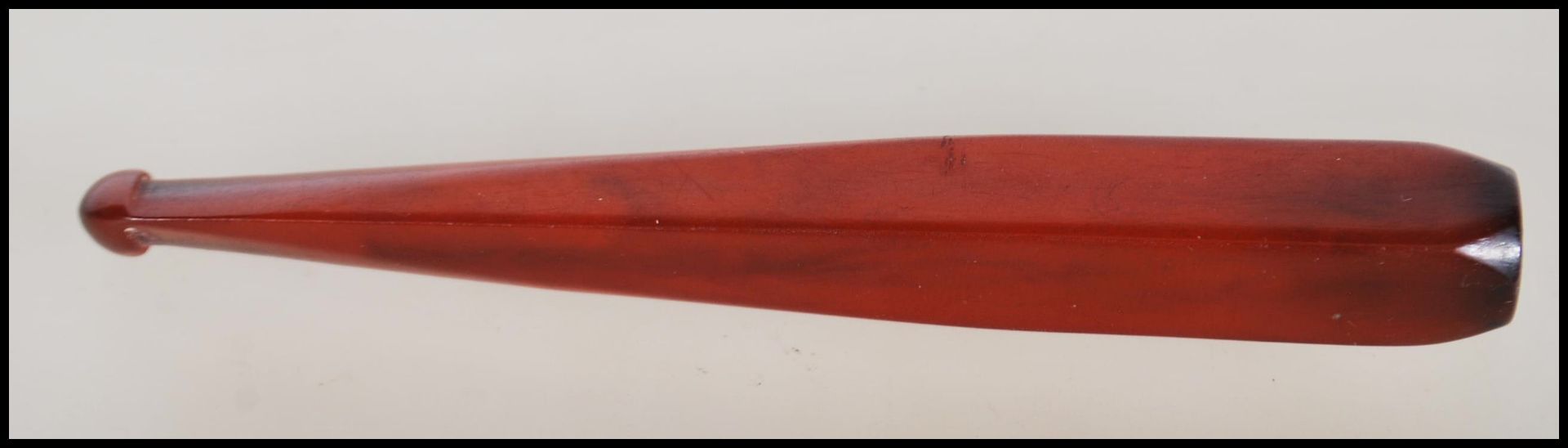 A vintage early 20th Century Art Deco bakelite cigarette cheroot holder being red in colour.